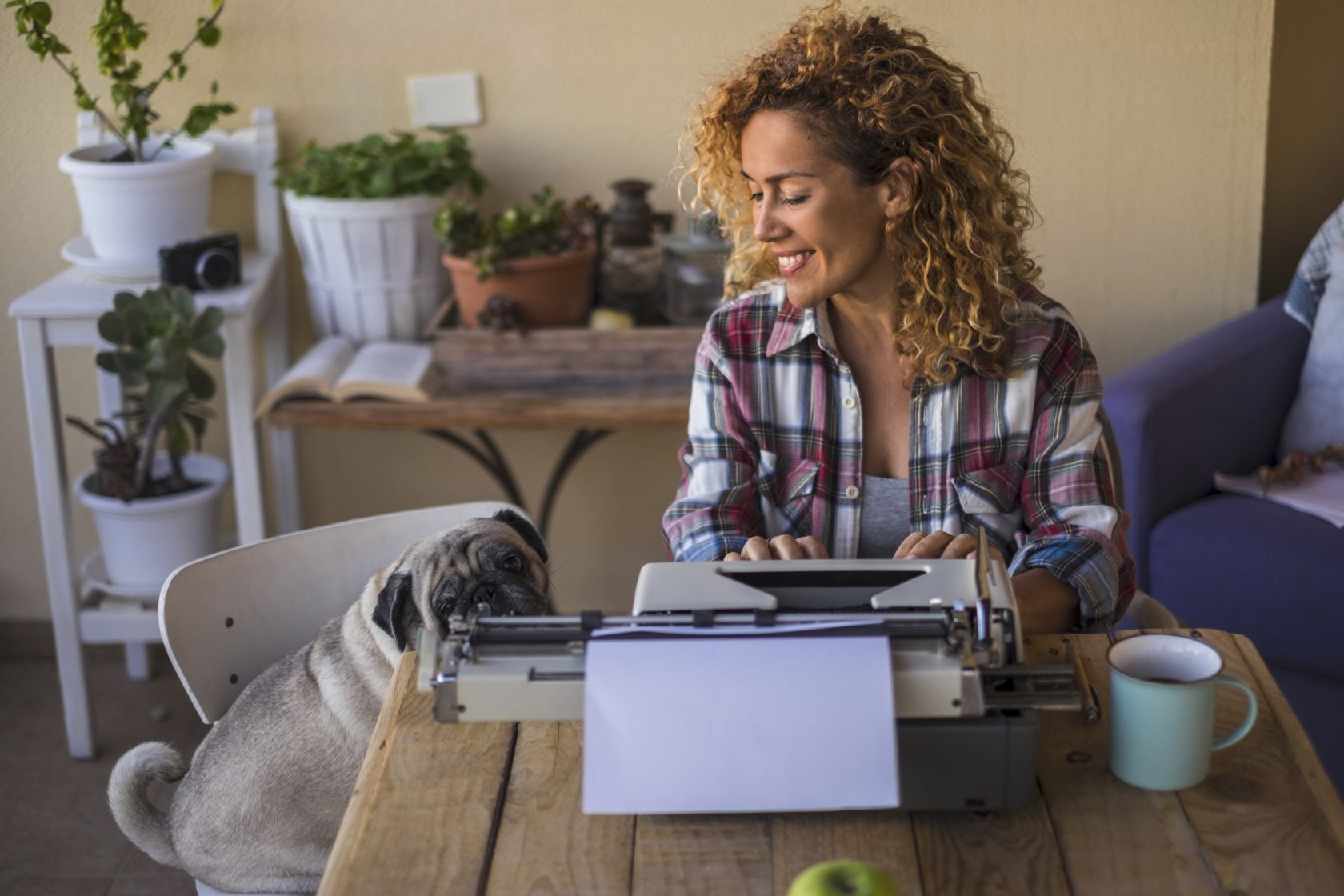 Middle age pretty caucasian woman use an old typewriter to write a blog or book