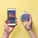 Hands holding smartphone connect to bluetooth speaker
