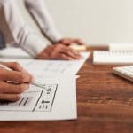UI Designer Drawing Wireframe of Website