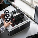 a new modern powerful computer video or graphics card installed in computer by serviceman