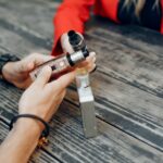 Stylish young couple with vape in a city