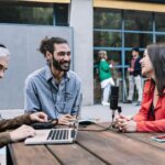 Young content creator journalist recording informal interview conversation with modern woman