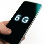 Cellphone in hand with 5G on display