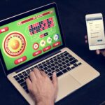 Hand holding credit card playing online gambling