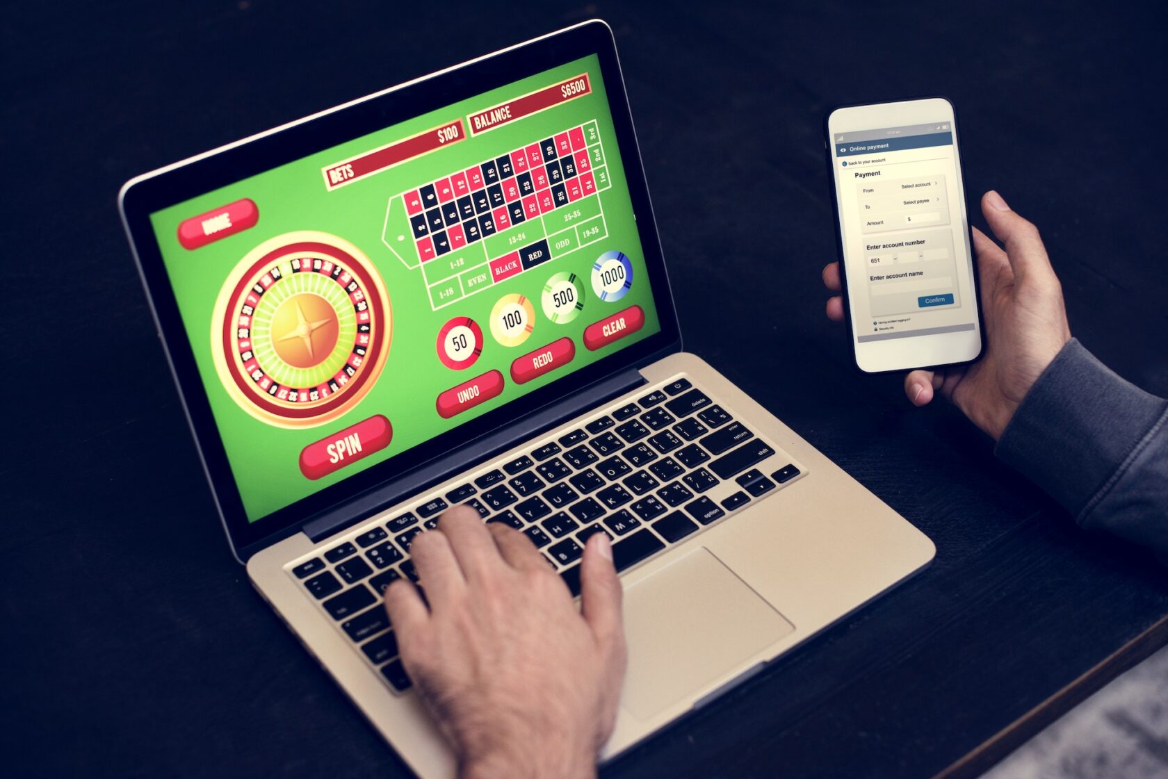 Hand holding credit card playing online gambling