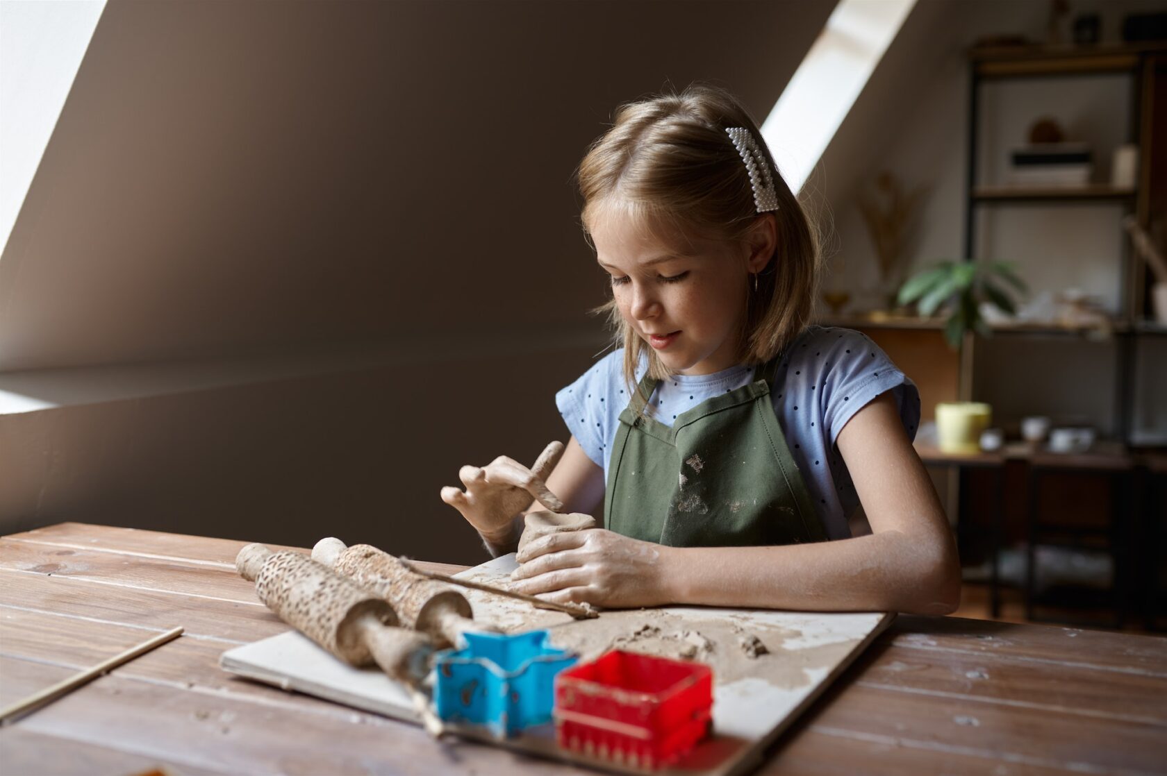 Little girl works with clay, kid in workshop - How to Keep Your Kids Away From Smartphones