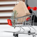 Online shopping concept. Shopping cart, laptop on the desk