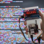 Hacker’s hand with a device for obtaining an access code and hacking access to data