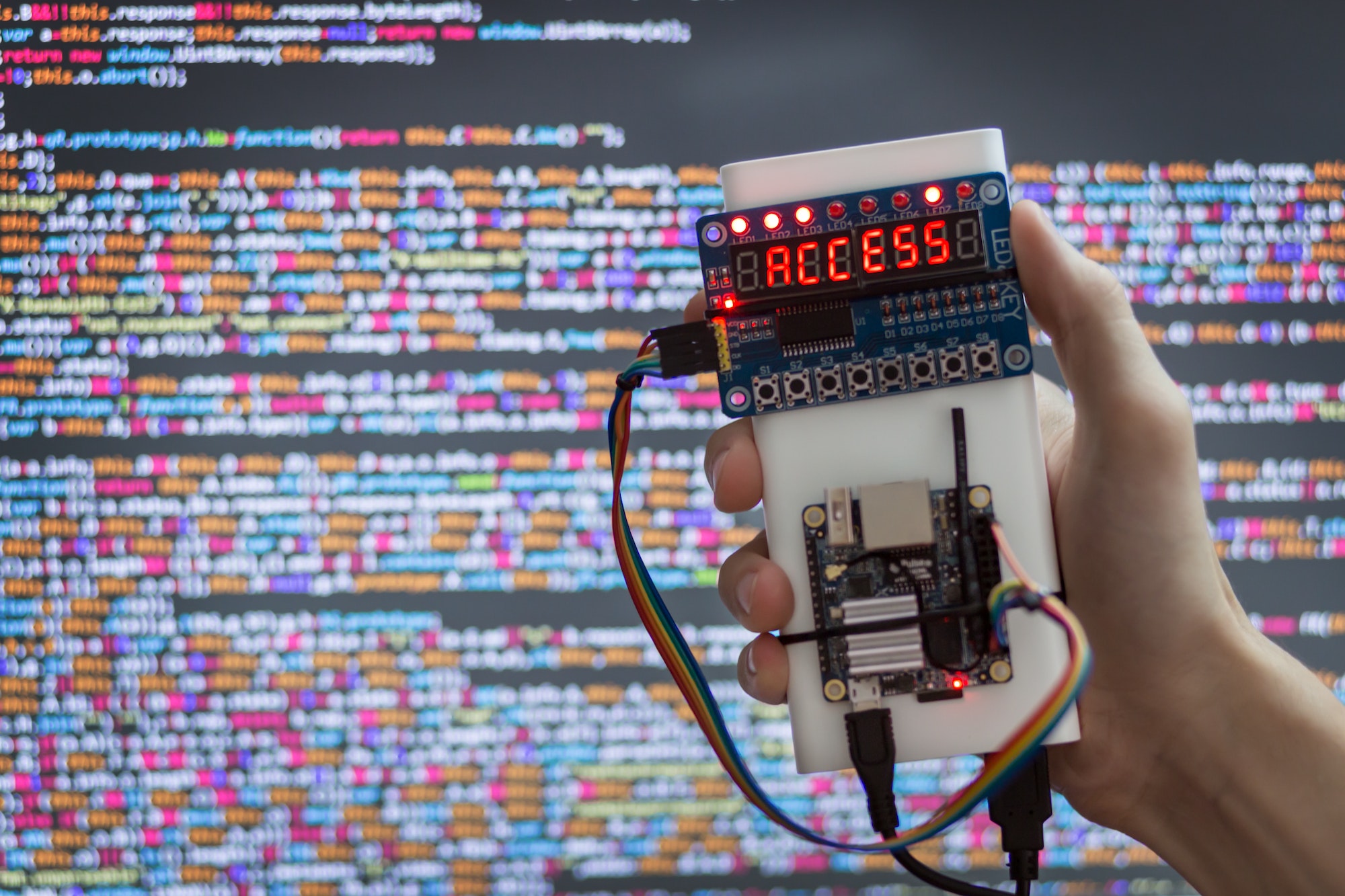 Hacker's hand with a device for obtaining an access code and hacking access to data