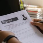 Resume from concept.Hand of man holding resume review to applying for job.