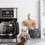 Preparation of hot coffee in the home kitchen in a coffee maker. Household electrical appliances.