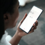 Woman Recording Voice Note On Mobile Phone