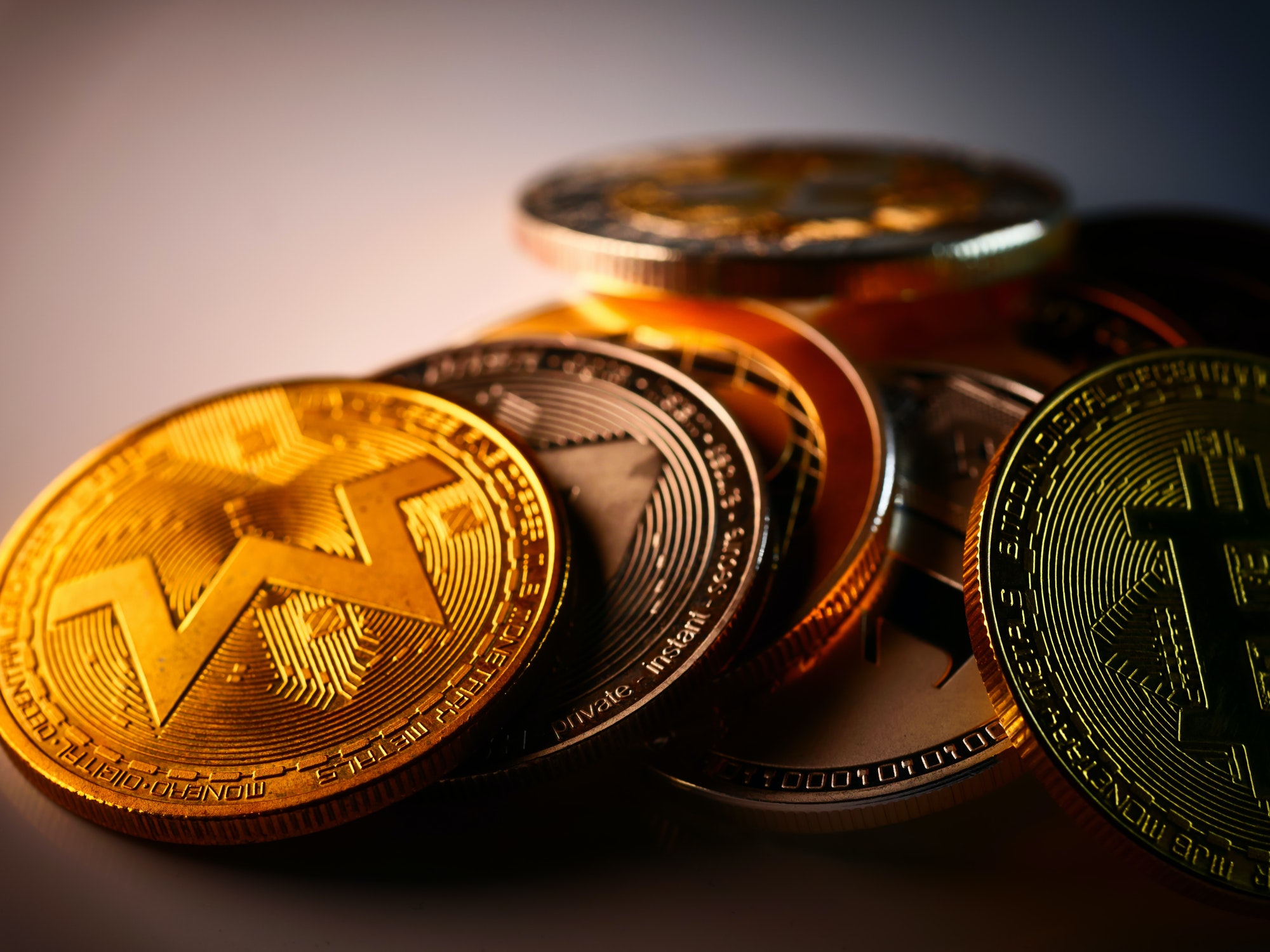 Closeup of monero, bitcoin, and other cryptocurrencies golden coins